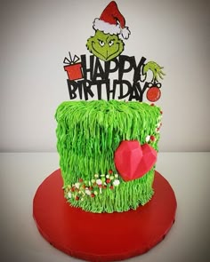 a green cake decorated with grass and the words happy birthday