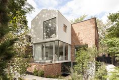 the house is surrounded by trees and bushes