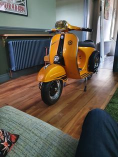 an orange scooter is parked in the living room