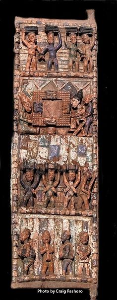 an intricately carved wooden panel with figures on it