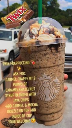 a person holding up a drink with toppings on it