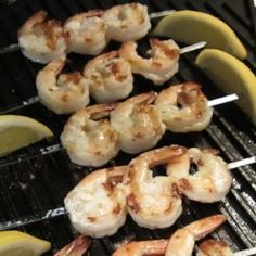 shrimp and banana skewers are cooking on the grill