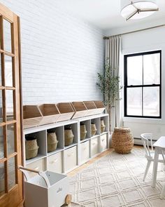 a white room with lots of storage and furniture