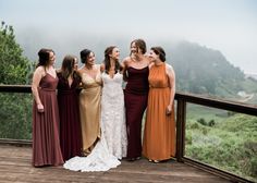 a group of women standing next to each other on a wooden deck