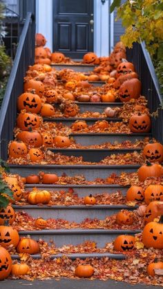 pumpkins on the steps in front of a house with leaves all over them and one is full of jack - o'- lantern faces