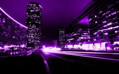 the city is lit up with purple lights