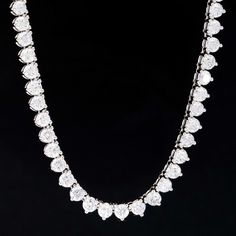 An incredibly rare find for a tennis necklace with this much firepower from designer Roberto Coin. A long, sparkly row of round brilliant diamonds is set in 3 martini prongs for maximum brilliance on the neck, making for the perfect necklace to wear during both day and night. Understated enough to wear by day, yet offers enough drama to pair with that LBD. 18kt White Gold 18.5" in length Diamonds are estimated to be G/H colors & VVS/SI1 clarities. GIA Standards Please see qualitative report for Iced Out Diamond Necklace For Anniversary, Iced Out Round Diamond Necklace, White Moissanite Tennis Necklace For Anniversary, Anniversary White Diamond Tennis Necklace, Diamond White Tennis Necklace With Moissanite Accents, White Tennis Necklace With Single Cut Diamonds For Anniversary, Moissanite Tennis Necklace With Diamond Accents In Diamond White, Anniversary White Tennis Necklace With Single Cut Diamonds, White Round Cut Crystal Tennis Necklace