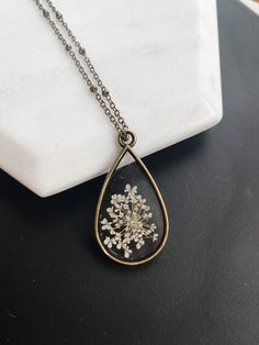 Real Pressed Flower Necklace 🖤 #pressedflowernecklace #pressedflowerjewelry #floralgifts #resinjewelrydiy #flowerresinnecklace #preservedflowergift #giftformom #realpressedflower #necklaceforher #minimalistjewelry #giftsfrometsy #handmadegiftguide #botanicalnecklace #realflowernecklace #resinjewelry #pressedflowerart #whiteaesthetic #brassnecklace #resindiy Anniversary Necklace With Pressed Flowers Pendant, Vintage Necklaces With Pressed Flowers For Jewelry Making, Vintage Birth Flower Necklaces For Jewelry Making, Vintage Jewelry With Pressed Flowers For Gifts, Vintage Jewelry With Pressed Flowers Gift, Vintage Pressed Flowers Jewelry Gift, Vintage Flower Necklaces With Pressed Flowers, Vintage Flower Necklace With Pressed Flowers, Vintage Gold Necklace With Pressed Flowers