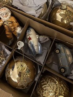 an open box filled with christmas ornaments on top of a table