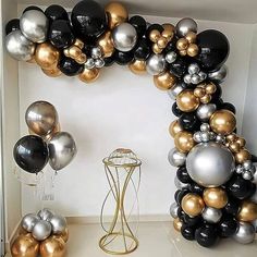 a bunch of balloons that are on a shelf in a room with white and black walls