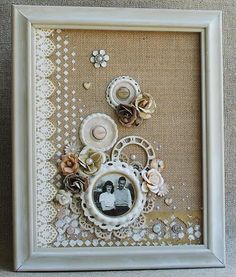 a white frame with flowers and buttons on it