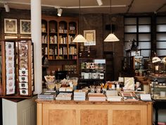 a store with lots of books on the counter and shelves full of stuff in it