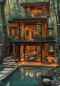 a house in the woods with a pool and stairs leading up to it's second story