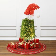 a small christmas tree with presents under it