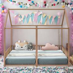 a child's bedroom with pink, blue and yellow decorations on the wall above the bed