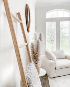 a living room filled with furniture and white walls