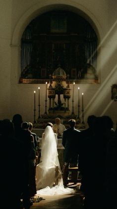 a bride and groom walking down the aisle at their wedding ceremony in front of an alter