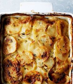 a casserole dish with potatoes and herbs