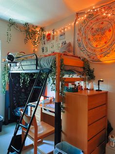 a bedroom with a bunk bed and desk in the corner, surrounded by plants on the wall