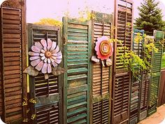 a row of wooden shutters with flowers on them