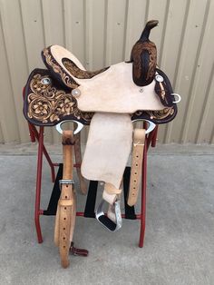 a horse saddle sitting on top of a wooden stand