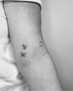 a woman's arm with butterflies on it and the words live love written in black ink