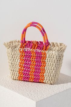 Stand out from the crowd this summer with Shiraleah's Sicily Mini Tote. Made from intricately woven paper straw with sturdy double handles, this bag is both practial and stylish. With its feminine orange and pink striped design it's easy to envision this bag alongside any warm weather outfit. Pair with other items from Shiraleah to complete your look! Chic Summer Style, Warm Weather Outfits, Chic Handbags, Sunset Colors, Straw Tote, Paper Straws, Woven Paper, Mini Tote, Woven Bag