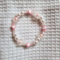 Aesthetic Bracelets With Words, Aesthetic Pink Bracelet, Cheap Pink Pearl Bracelet For Beach, Pink Flower-shaped Beaded Charm Bracelet, Dainty Pink Beaded Friendship Bracelets, Pink Beaded Dainty Pearl Bracelet, Dainty Pink Beaded Pearl Bracelet, Pink Dainty Adjustable Heart Bracelet, Feminine Pink Bracelets For Gift