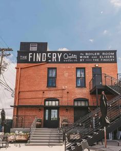 the findley hotel is located on the corner of an old brick building with stairs leading up to it