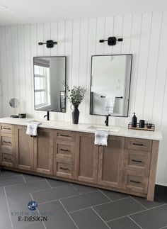 a large bathroom with two sinks and mirrors on the wall next to eachother