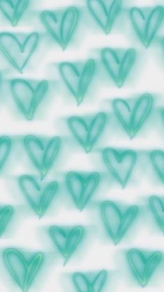 many green hearts are arranged in the shape of heart shapes on a light blue background