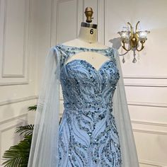 a dress on display in front of a chandelier