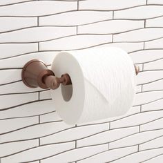 a roll of toilet paper is hanging on the wall