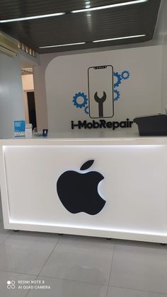 an apple logo is displayed on the front of a reception counter at a company's office