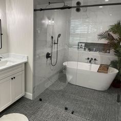 a white bath tub sitting next to a walk in shower