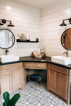 a bathroom with two sinks and mirrors on the wall above it is decorated in black and white