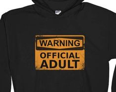 a black hoodie with an orange warning sign on the front saying,'warning official adult '