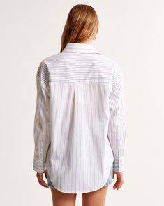 Comfy shirt in our soft poplin fabric and oversized-fit silhouette, featuring left chest pocket, classic collar, button-up front and curved hem. Oversized Poplin Shirt, White Stripes Shirt, Comfy Shirts, Oversized Silhouette, Poplin Fabric, Striped Shirt, Oversized Fits, Modern Woman, Stripes Pattern