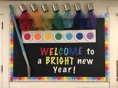 a welcome to a bright new year sign with paint brushes and crayons on it