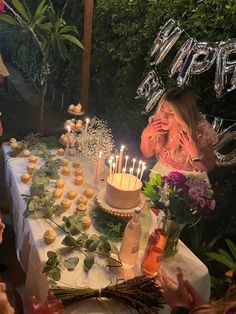 a girl blowing out candles on her birthday cake