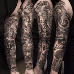 three men with tattoos on their arms and legs are standing in front of each other