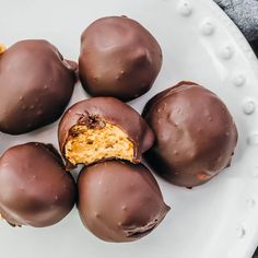 chocolate covered desserts are on a white plate