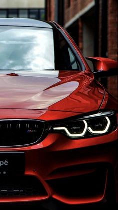 the front end of a red bmw car