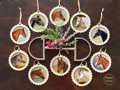 twelve horse ornament hanging on a wooden table with red berries and greenery