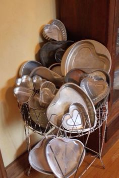 a bunch of pots and pans that are sitting on a rack in the corner