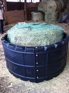 hay bales are stacked on top of each other in a storage area at a farm