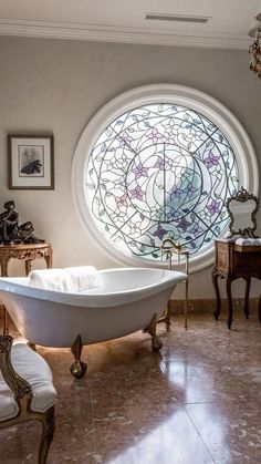 a bath tub sitting in front of a round window