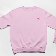 Flamingo Embroidered Sweatshirt. Soft Cotton drop shoulder style with stylish fit. Designed and Embroidered in the UK. Unisex Fit. Vegan.   JUMPER INFO Flamingo embroidered by twin needle stitching. We use sustainable fabric and the jumper is fair trade certified. Sweatshop free and WRAP certified. Shipped in recyclable and biodegradable packaging. Plastic free. Pink Embroidered Sweatshirt With Relaxed Fit, Pink Embroidered Relaxed Fit Sweatshirt, Long Sleeve Embroidered Pink T-shirt, Pink Embroidered Long Sleeve T-shirt, Pink Long Sleeve Embroidered T-shirt, Casual Cotton Flamingo Print Tops, Casual Cotton Tops With Flamingo Print, Pink Embroidered Crew Neck Top, Embroidered Flamingo