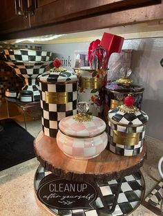 the kitchen counter is covered with black and white checkerboard plates, jars and containers