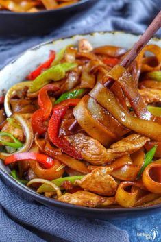 chicken chow fun stir fry in a bowl with chopsticks on the side and text overlay